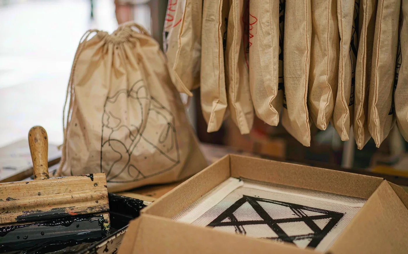 Screen printing a logo onto cotton bags and kraft gift boxes